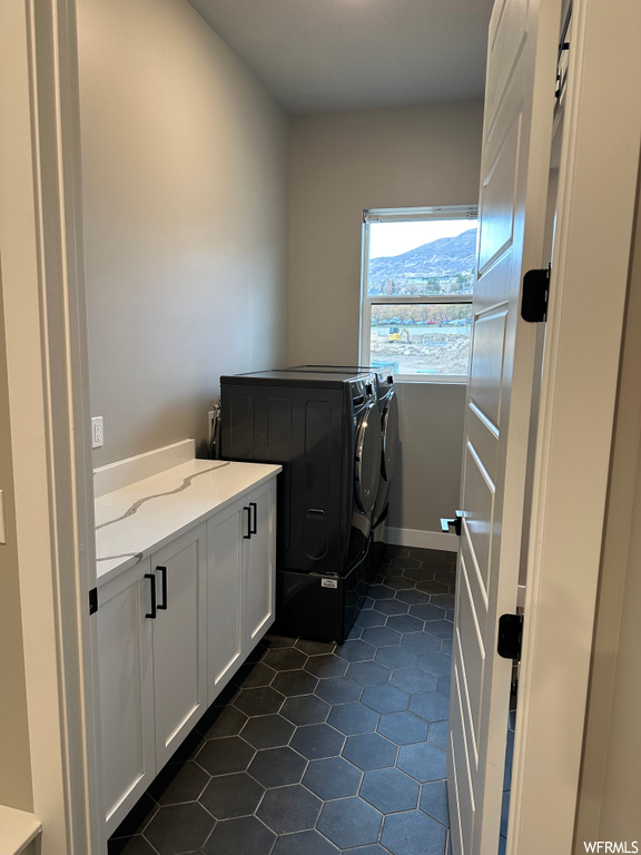 laundry area featuring natural light and tile floors