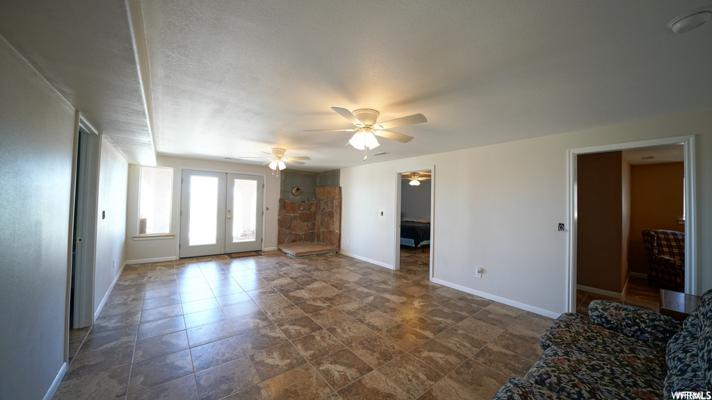 living room featuring natural light, tile flooring, and a ceiling fan