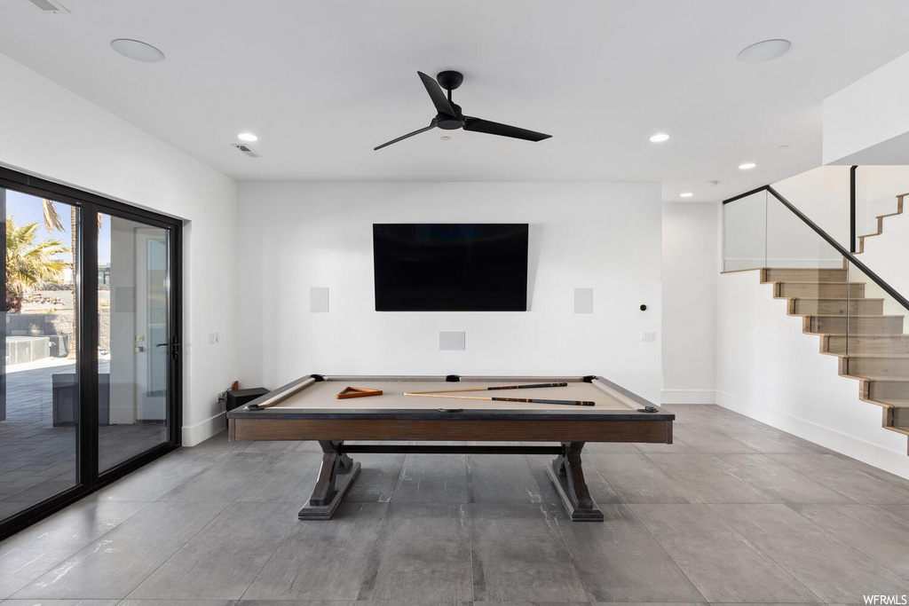 recreation room with a ceiling fan and TV
