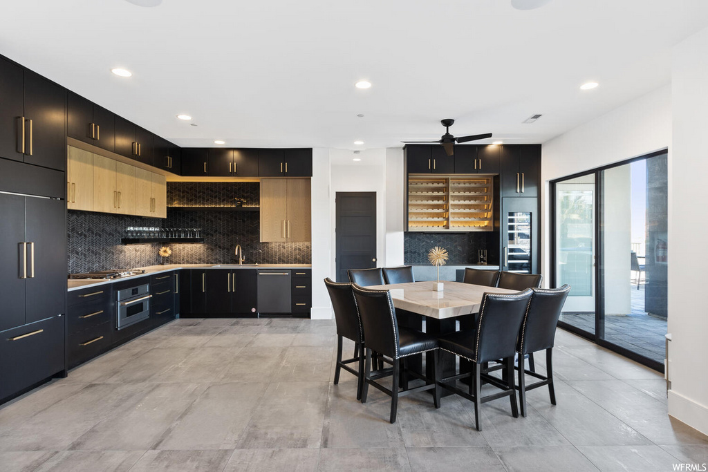 kitchen with dishwasher, oven, dark brown cabinetry, and light tile flooring