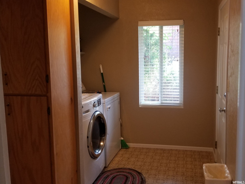 laundry room with natural light and washer / dryer