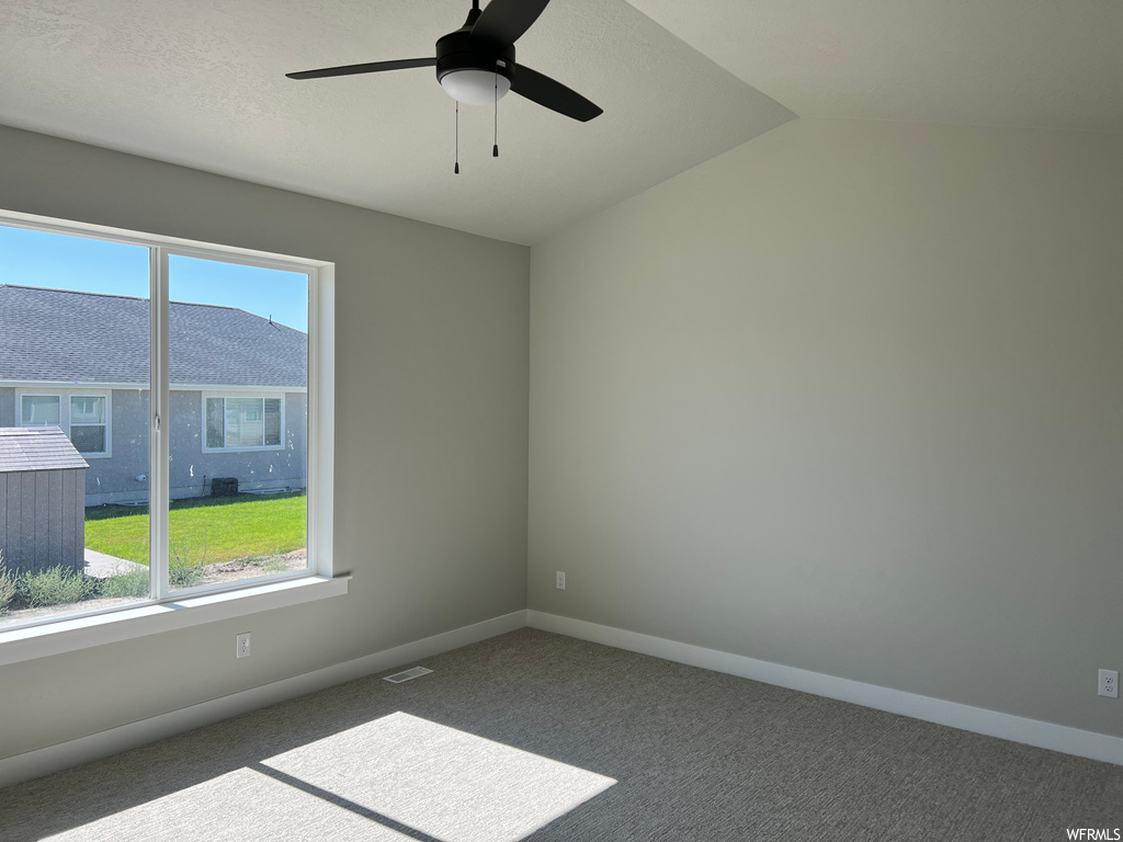 Spare room with light carpet and ceiling fan