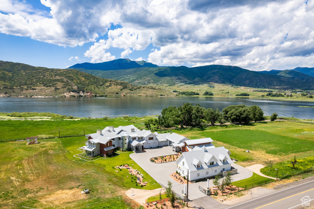 View of subject property featuring a water and mountain view