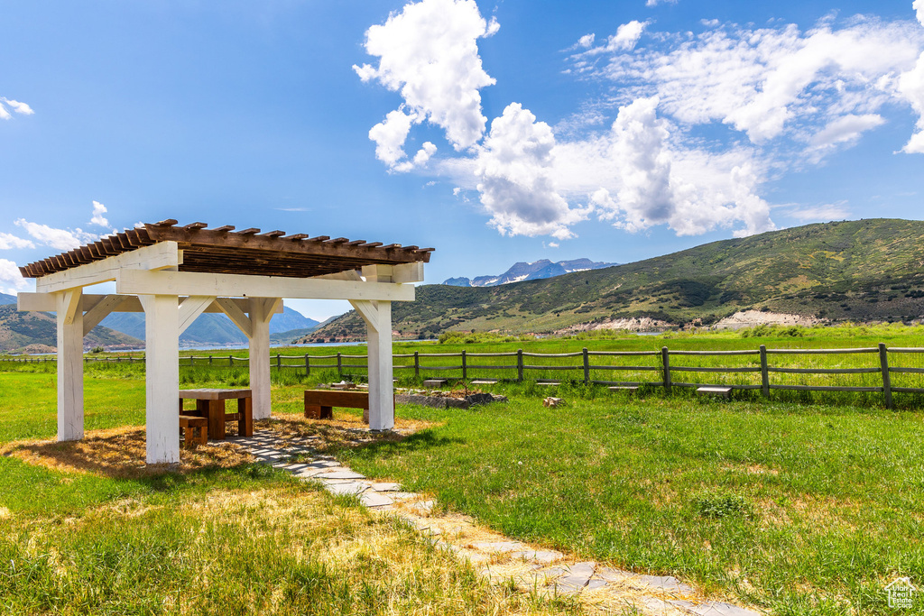 View of yard with a mountain view, a rural view, and a pergola