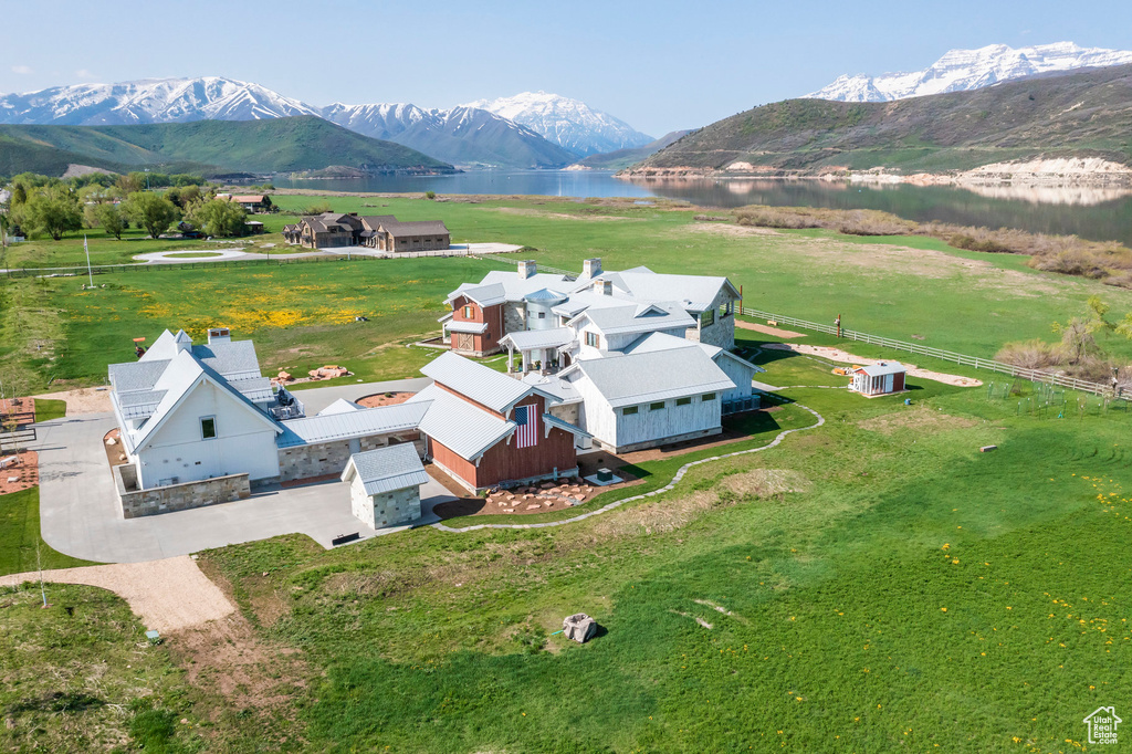 View of subject property with a water and mountain view