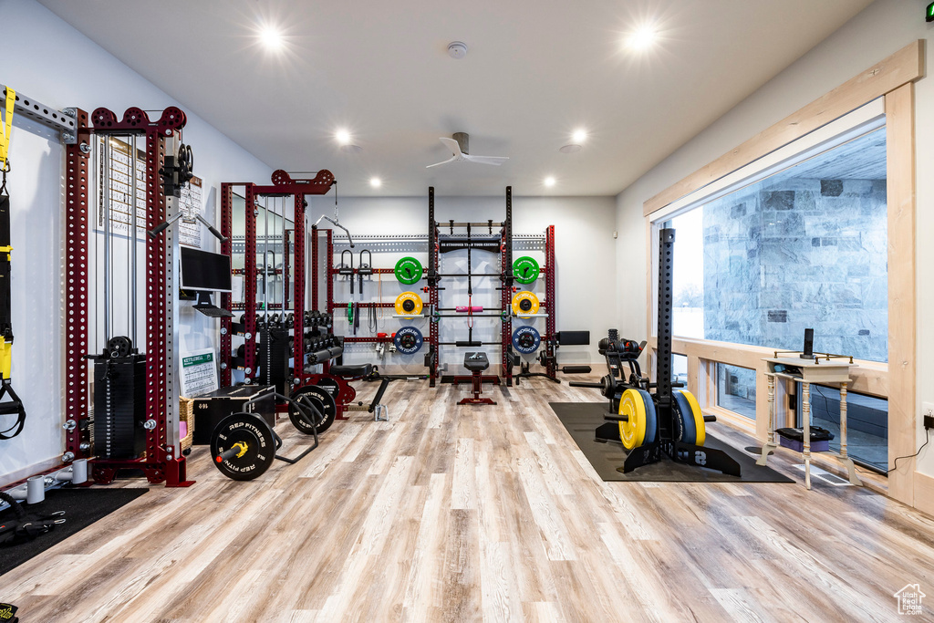 Exercise area with wood finished floors, recessed lighting, and ceiling fan