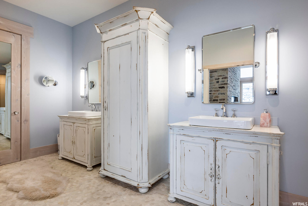 Bathroom with vanity with extensive cabinet space and dual sinks