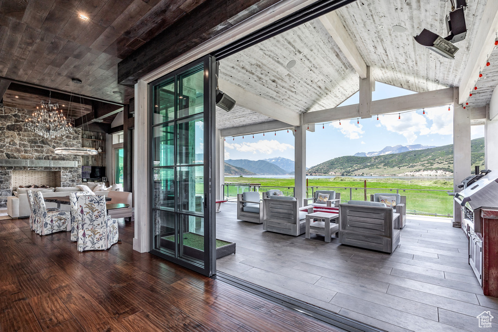 Wooden deck with an outdoor hangout area and a mountain view