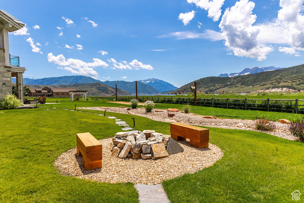 View of yard with an outdoor fire pit and a mountain view