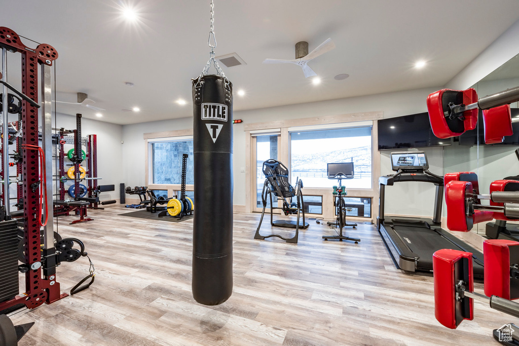 Gym featuring wood finished floors, recessed lighting, a ceiling fan, and baseboards