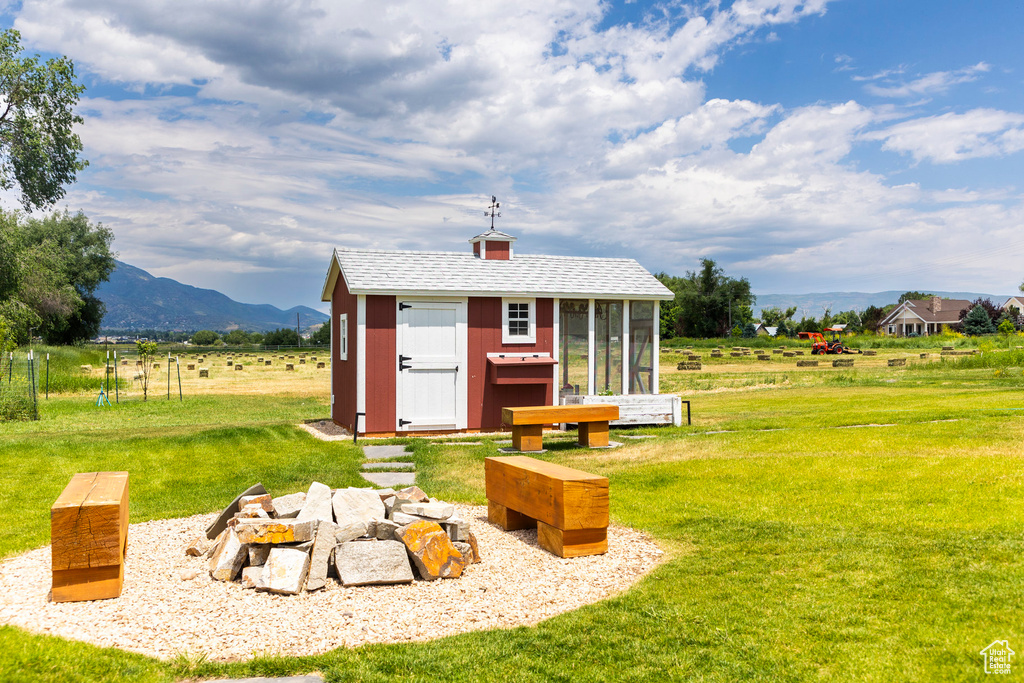 View of shed with a mountain view and a rural view