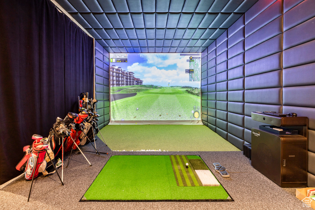 Rec room featuring golf simulator, carpet flooring, and golf course view
