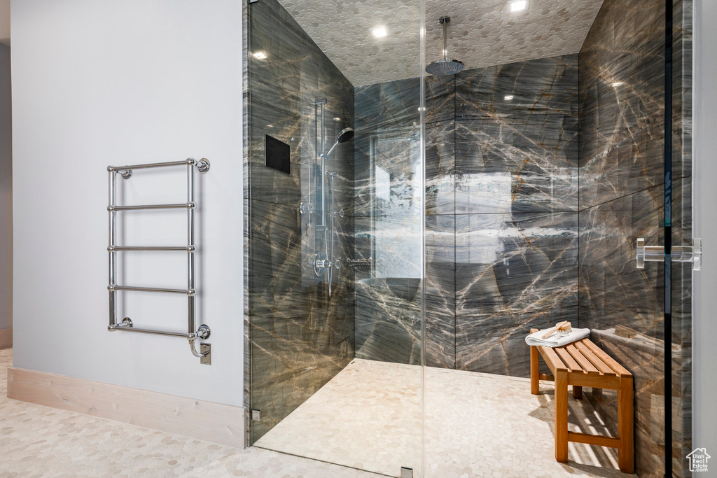 Bathroom featuring a marble finish shower and recessed lighting