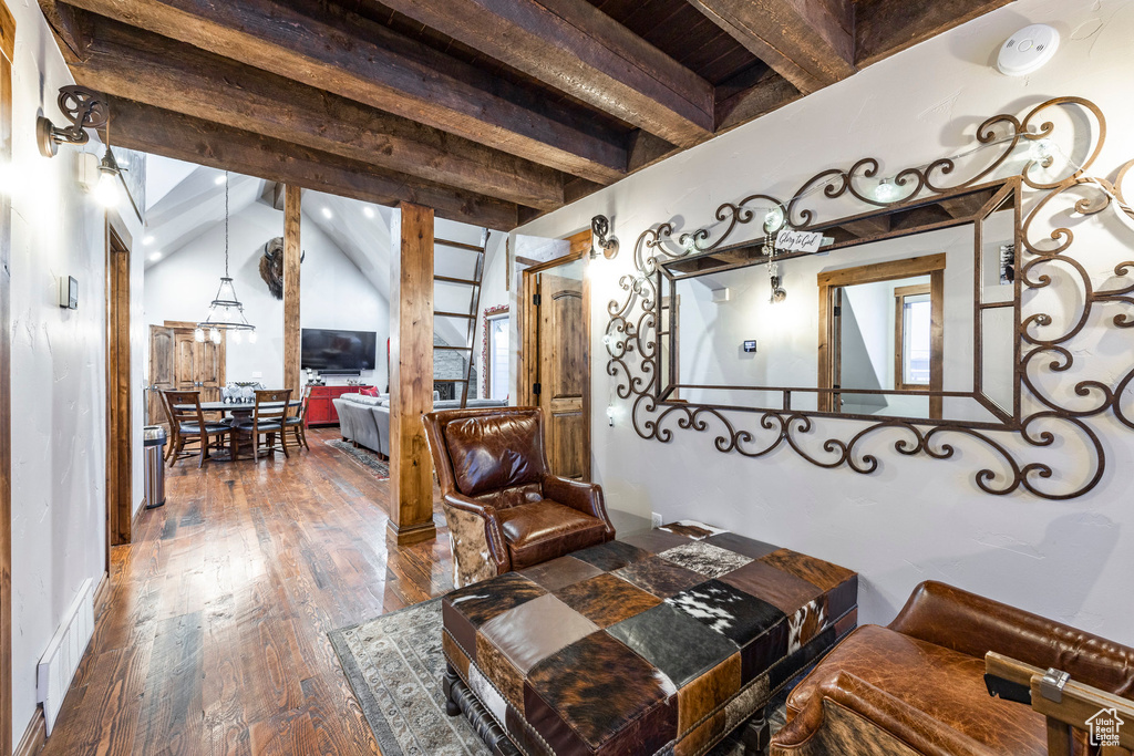 Living area featuring beamed ceiling and wood finished floors