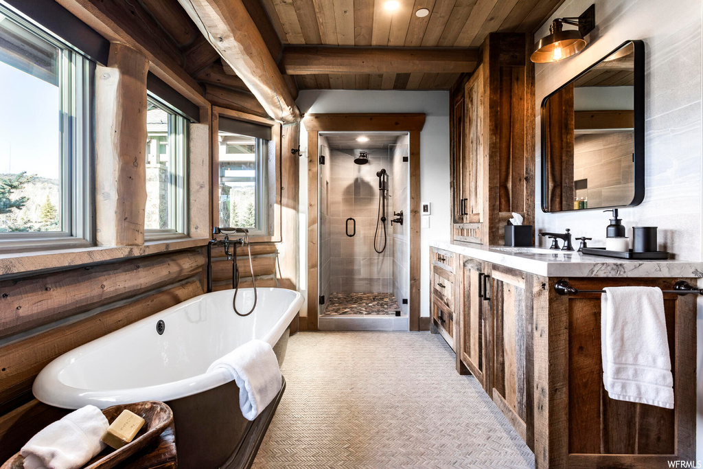 Bathroom with shower with separate bathtub, beam ceiling, large vanity, and wooden ceiling