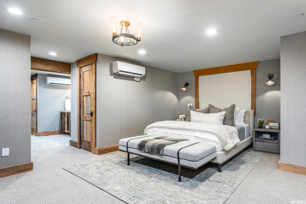 Carpeted bedroom with an AC wall unit and a notable chandelier