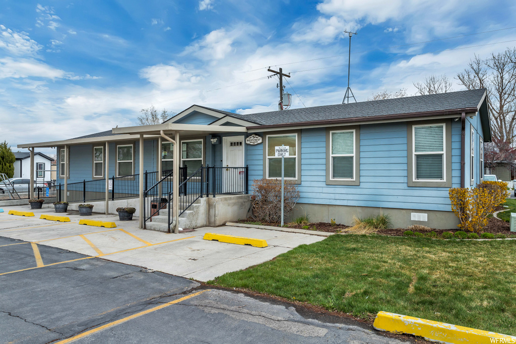 single story home featuring a front lawn
