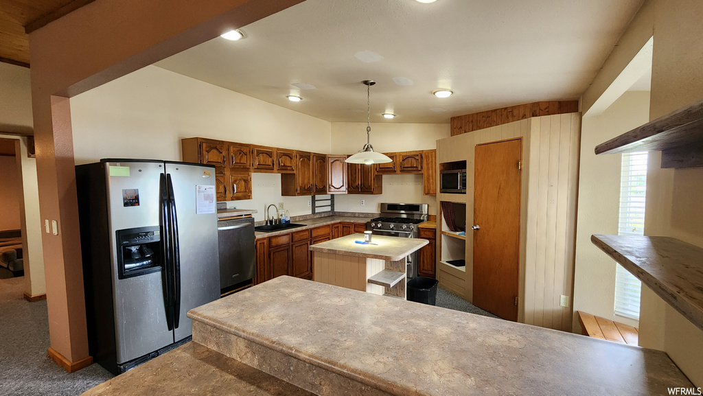 Kitchen featuring refrigerator, dishwasher, dark brown cabinetry, and pendant lighting