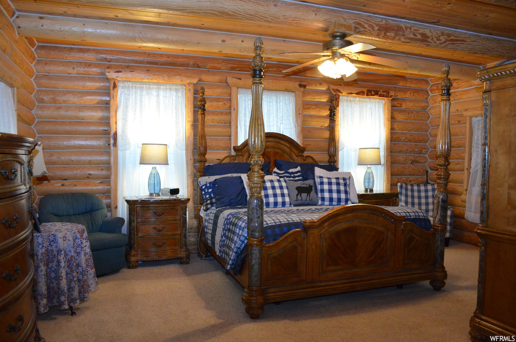 Bedroom with carpet and wood beam ceiling