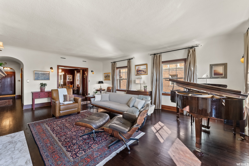 Living room with dark hardwood flooring and a textured ceiling