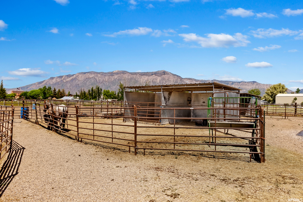 view of horse barn featuring a mountain view