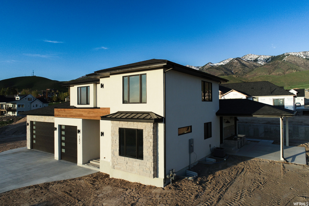 View of front of home with garage and a mountain view