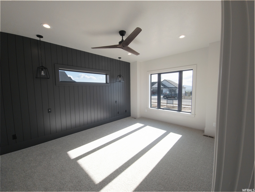 Spare room featuring ceiling fan and carpet flooring