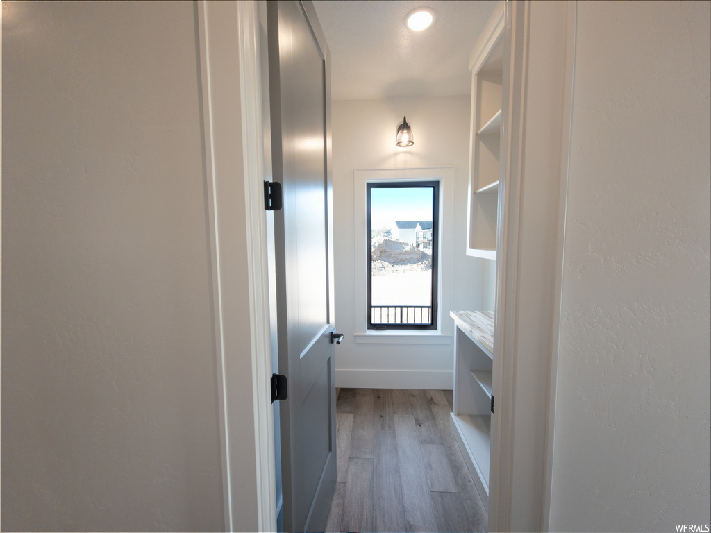 Hallway with hardwood flooring