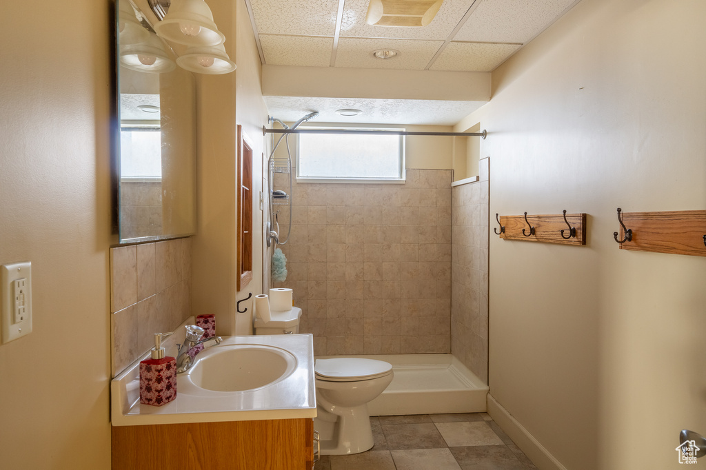 Bathroom with plenty of natural light, toilet, oversized vanity, and tile flooring