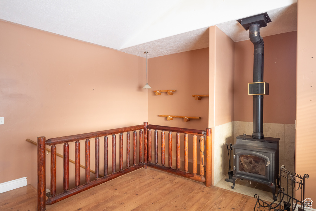 Stairs featuring light hardwood / wood-style flooring and a wood stove