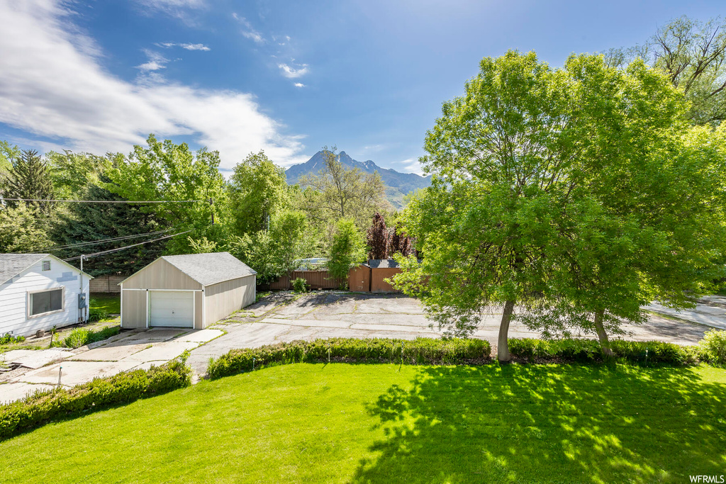 View of yard with a mountain view and garage