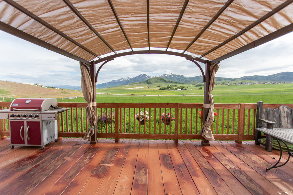 Deck featuring a yard and a mountain view