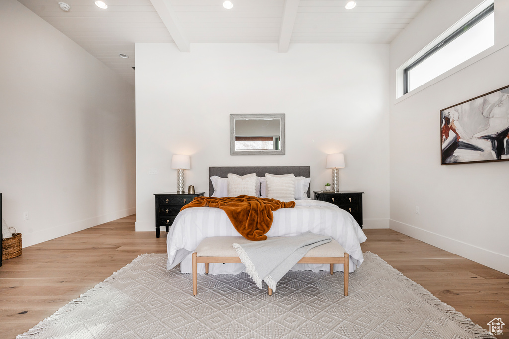 Bedroom featuring light wood-type flooring and beamed ceiling