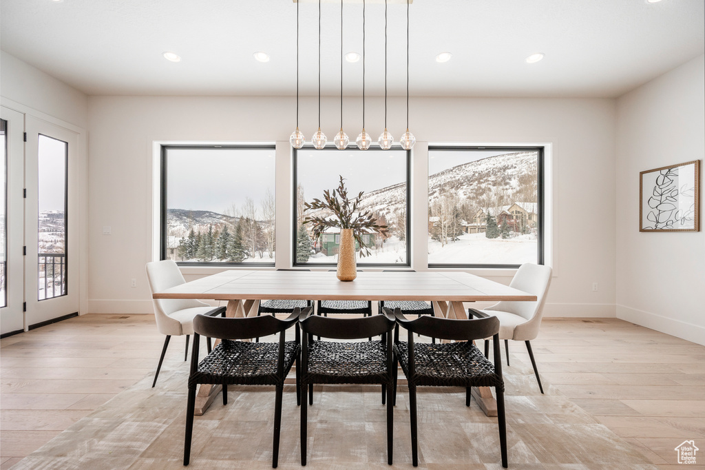 Dining room with light hardwood / wood-style flooring and a mountain view
