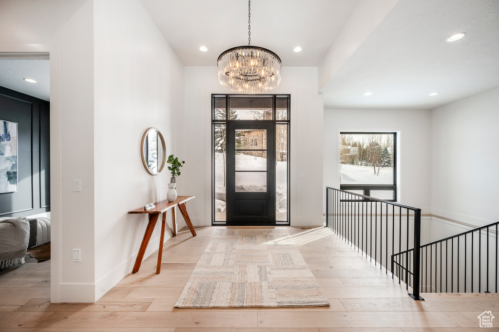 Foyer entrance featuring a chandelier and light hardwood / wood-style flooring