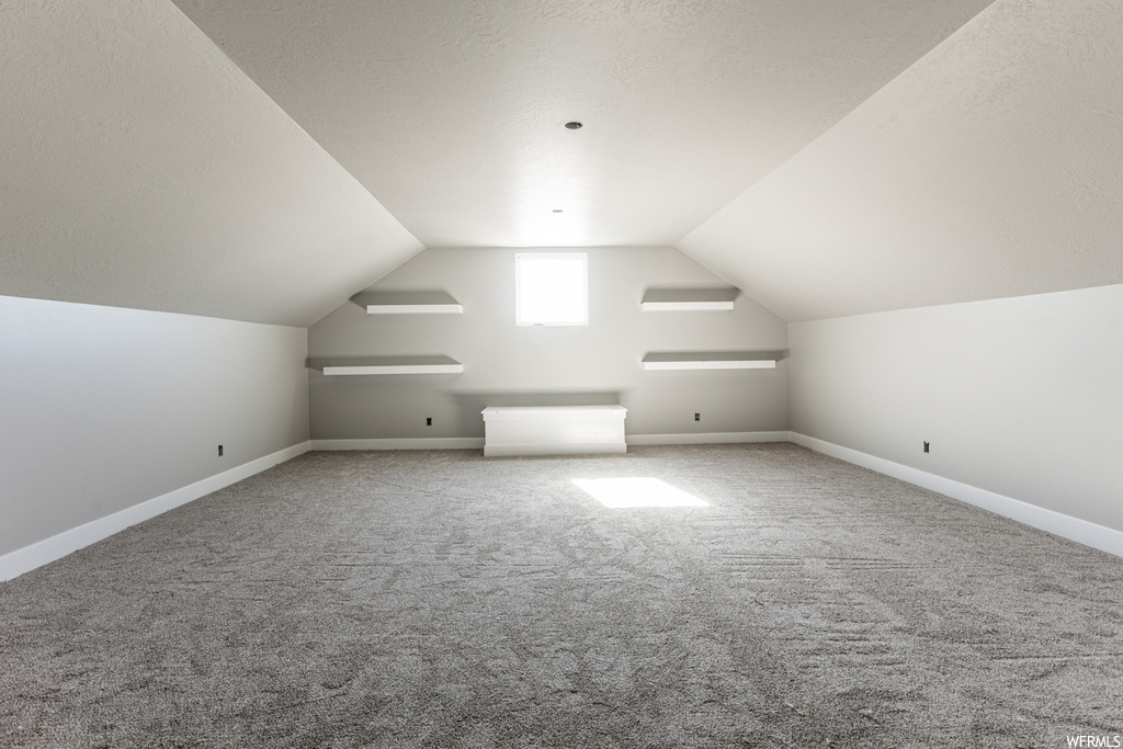 Bonus room featuring carpet floors and lofted ceiling