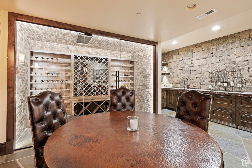 Wine cellar with sink and light tile floors