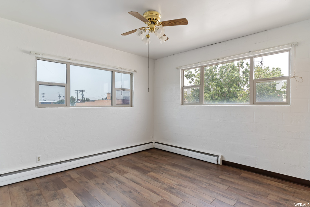 Empty room with light hardwood floors and ceiling fan