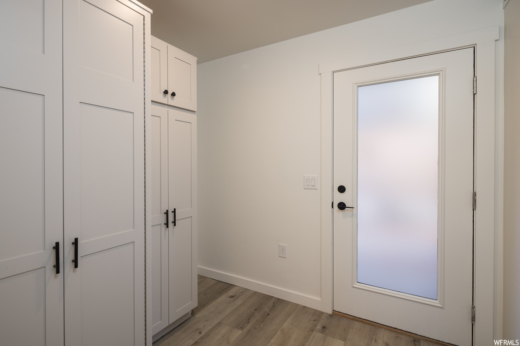 Doorway to outside with light hardwood / wood-style floors