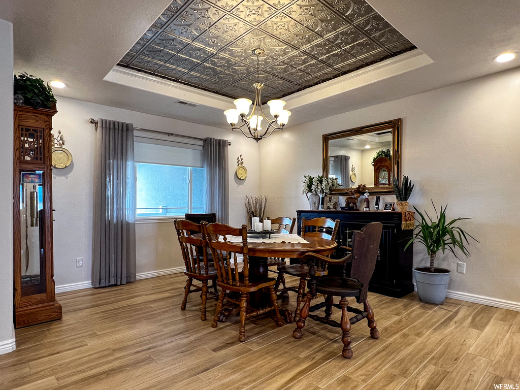 Hardwood floored dining room featuring natural light