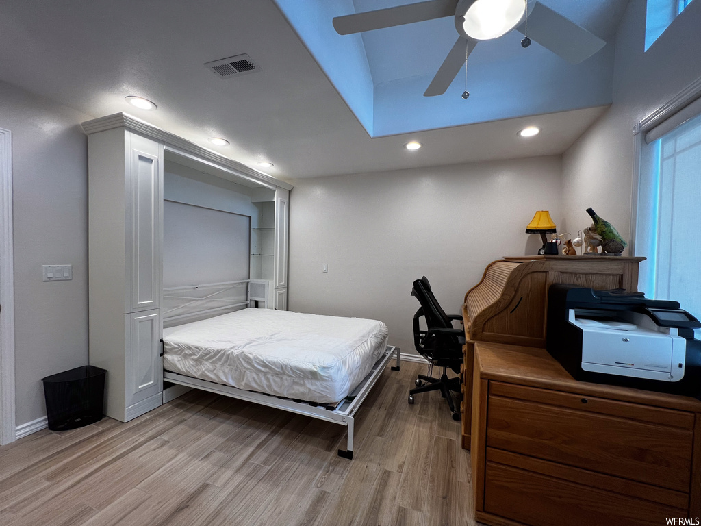 Bedroom with wood-type flooring and a ceiling fan