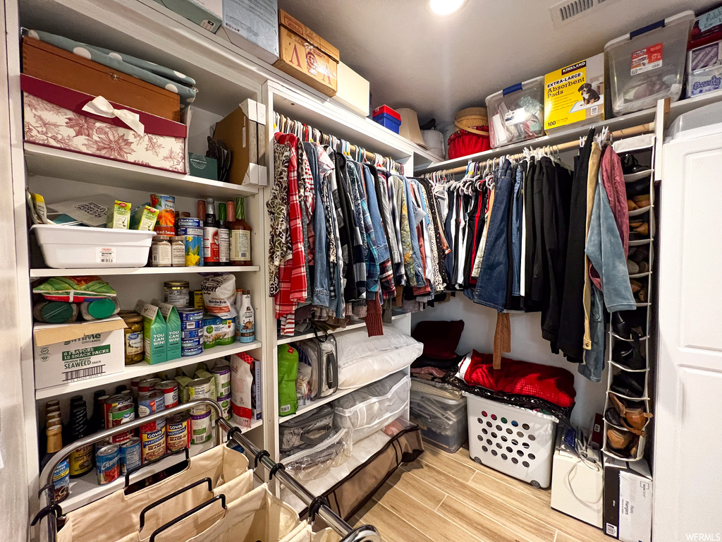 Walk in closet featuring wood-type flooring