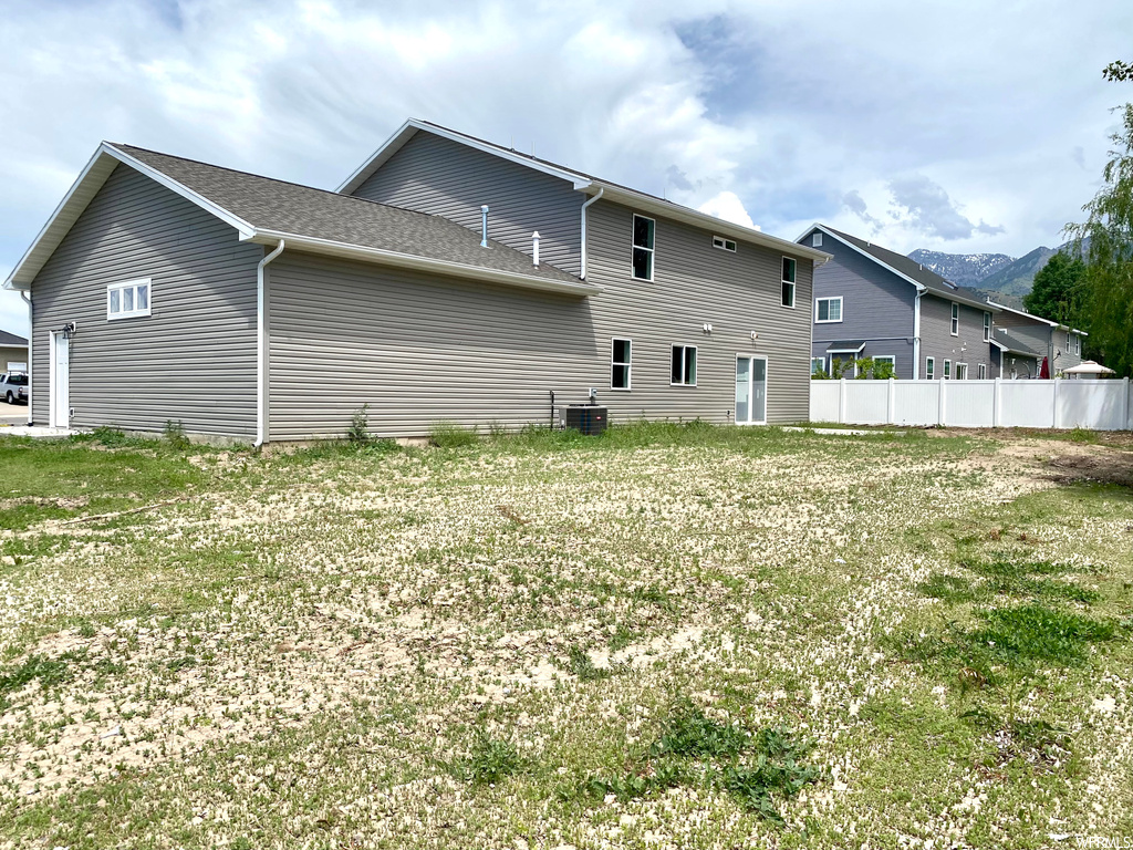 Back of house featuring central AC