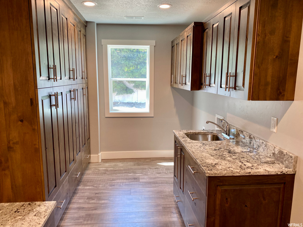 Kitchen featuring natural light and light hardwood floors