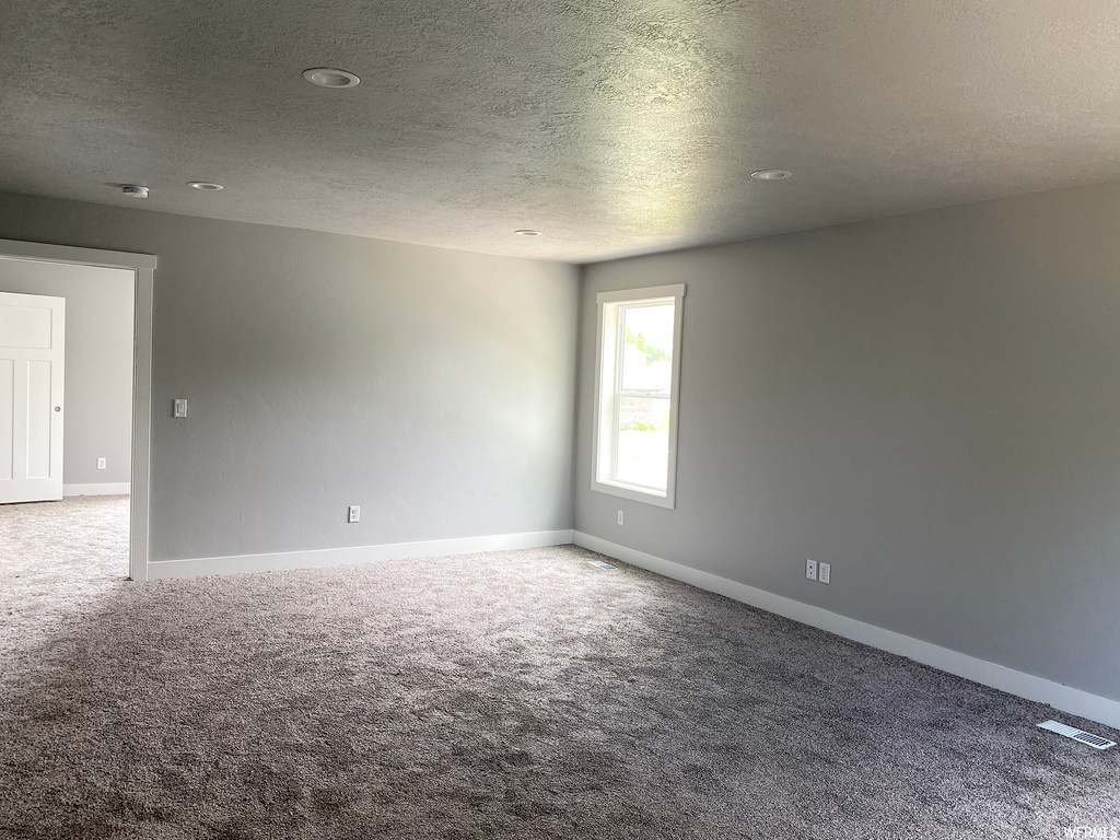 Spare room featuring carpet