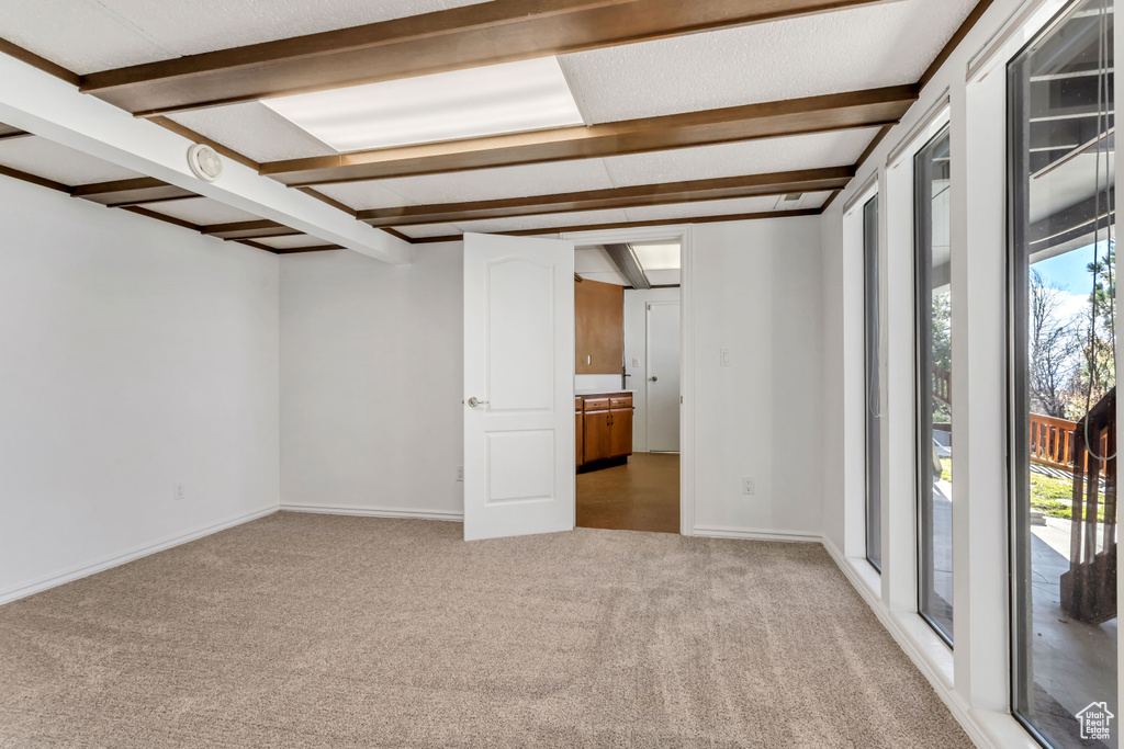 Interior space with plenty of natural light and light colored carpet