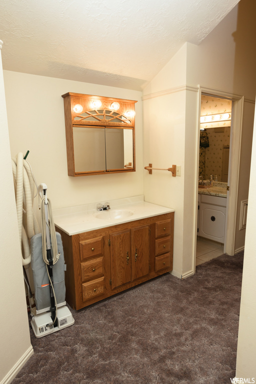 Bathroom with tile floors, mirror, and dual bowl vanity