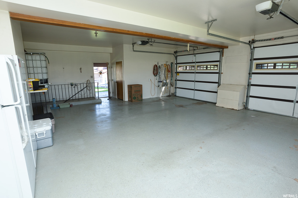 Garage featuring white fridge