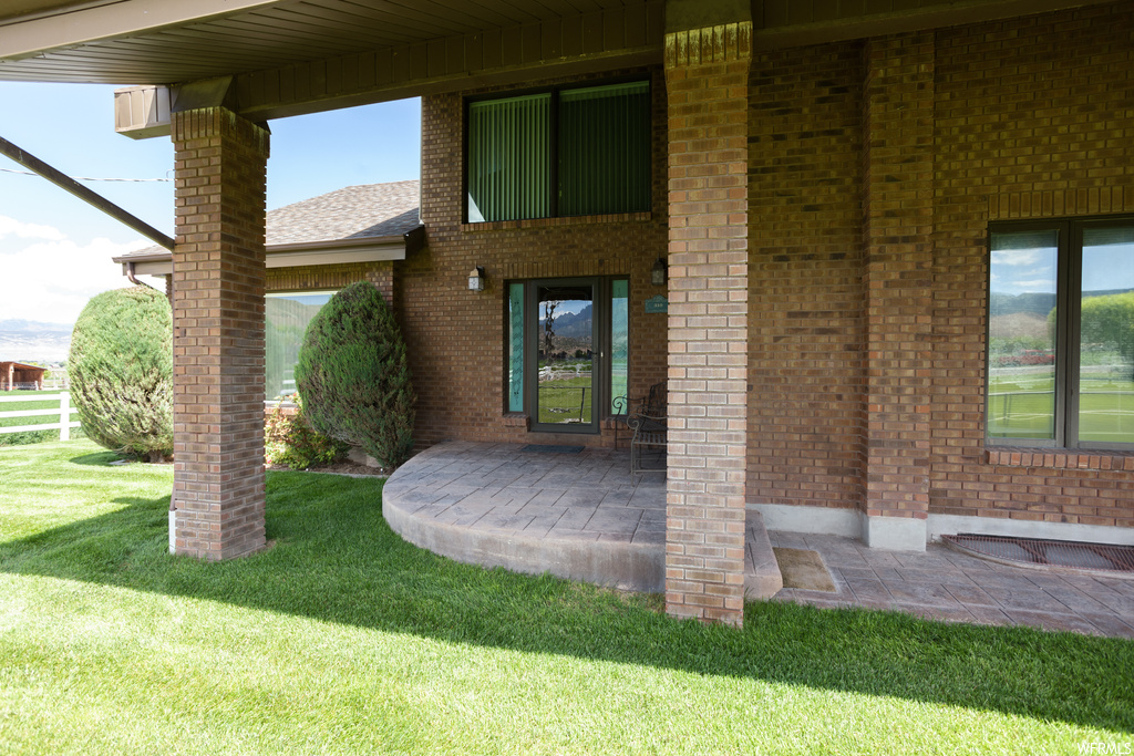 Doorway to property with a lawn