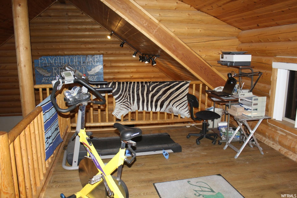 Exercise room with hardwood flooring